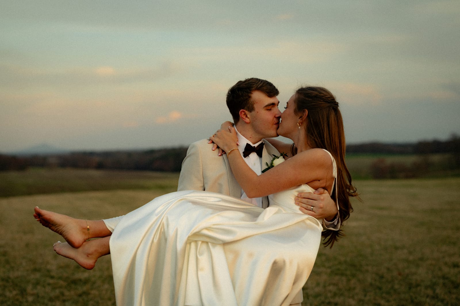 A couple embracing at golden hour on their wedding day